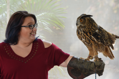 A woman holding an Eurasian Eagle-Owl on a glove