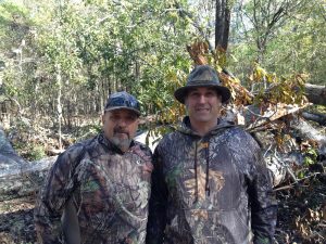 Frank Wiley and Mark Michaels wearing camo in the woods