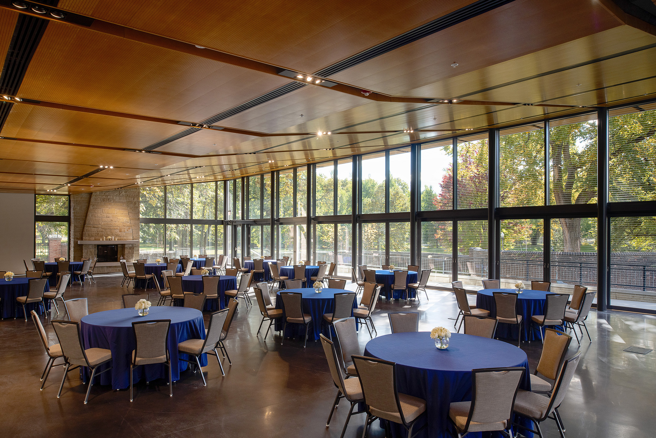 Several round tables and chairs inside The Garden Room