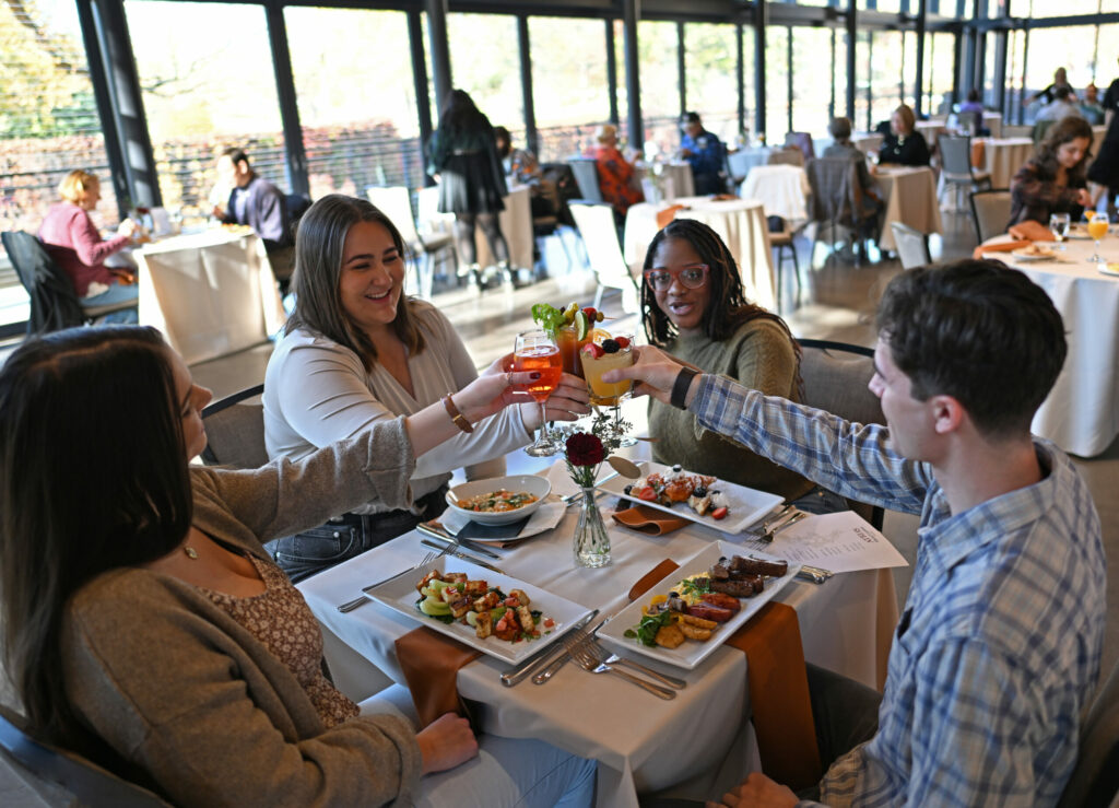 Four people toasting at a brunch event