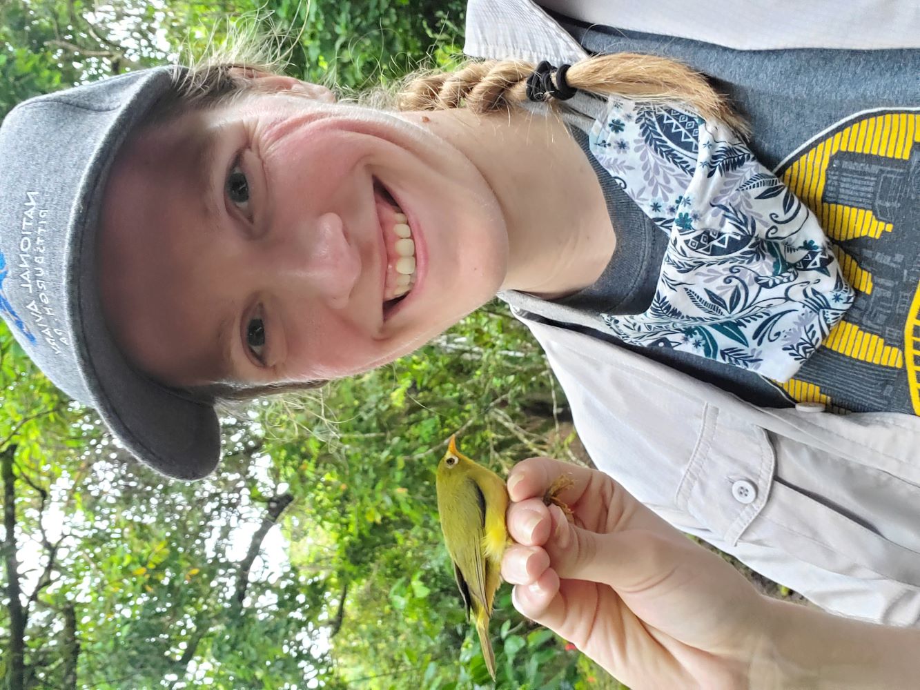 National Aviary Senior Aviculturist, Bri Crane holding a Nosa while in the Mariana Islands with the MAC Project
