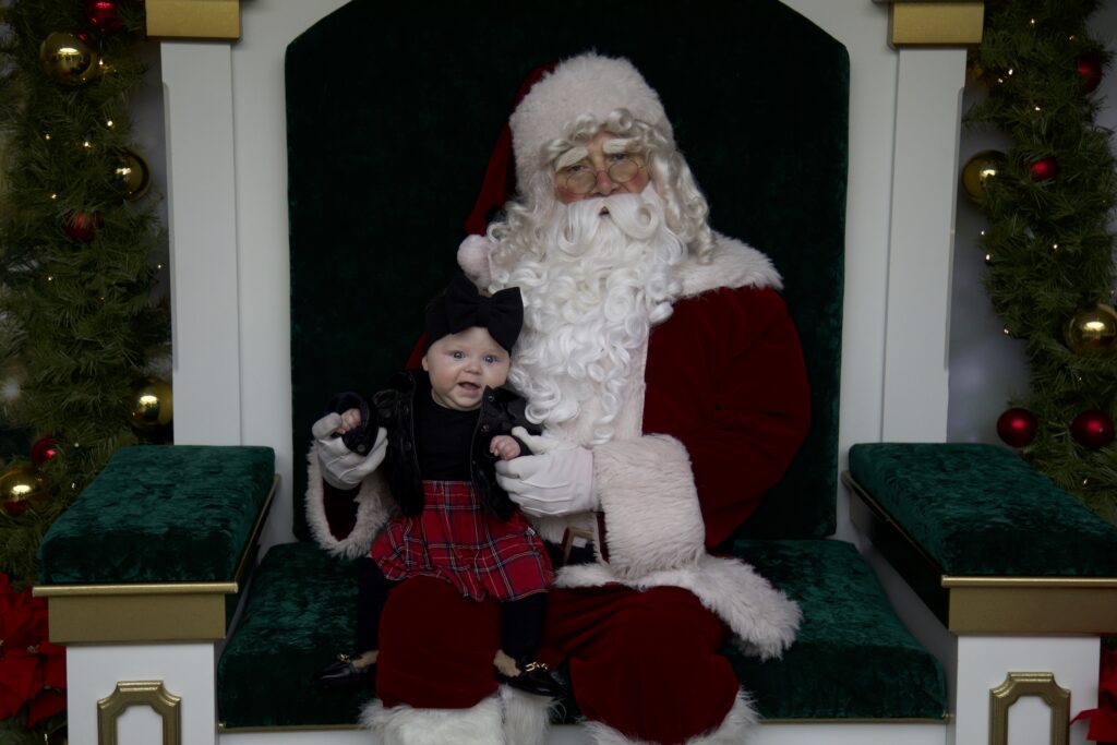 A baby with Santa Claus