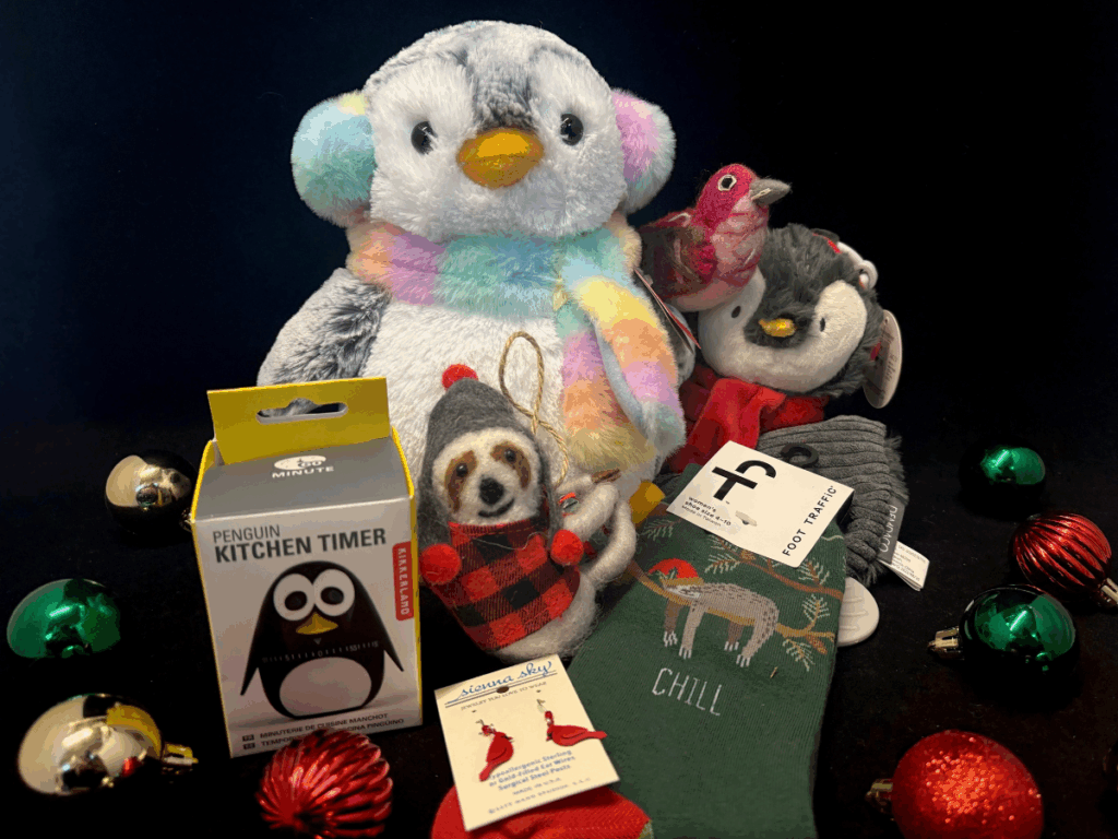 Plush penguin and sloth, penguin kitchen timer, earrings, sloth socks, and ornaments