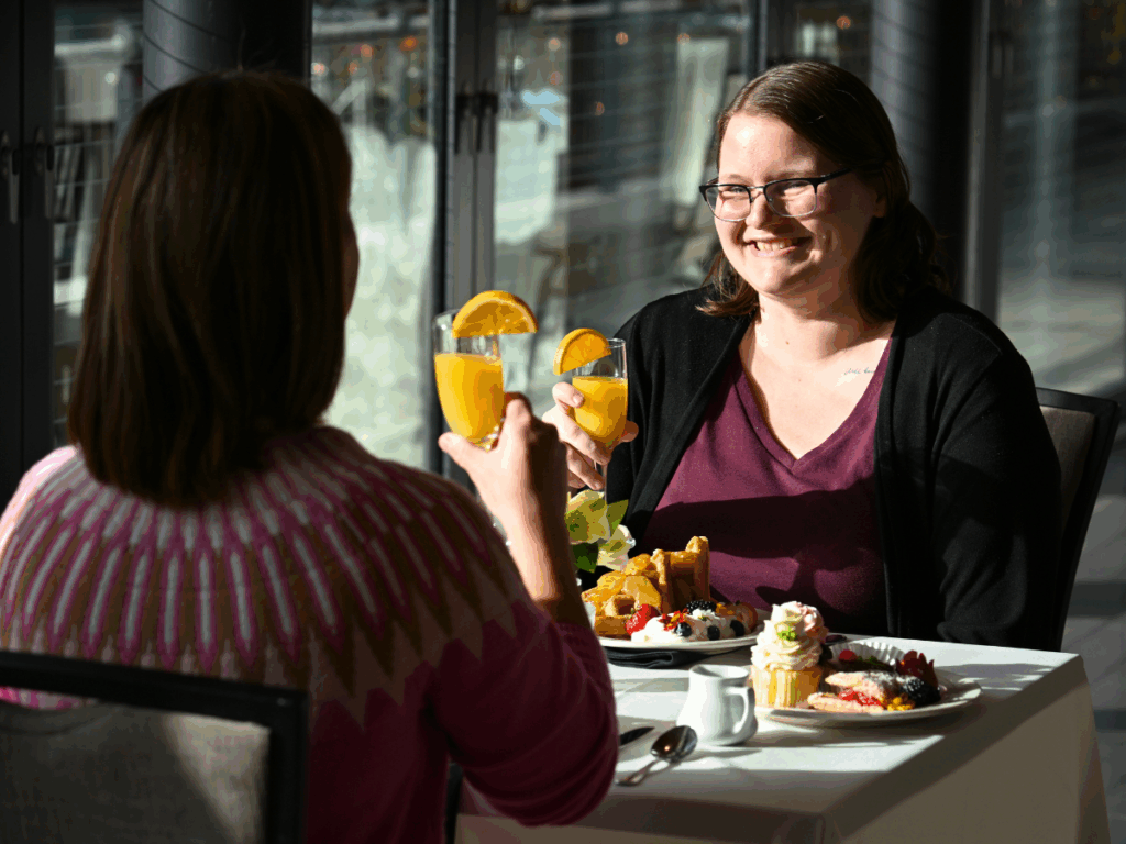Two friends enjoying a mimosa