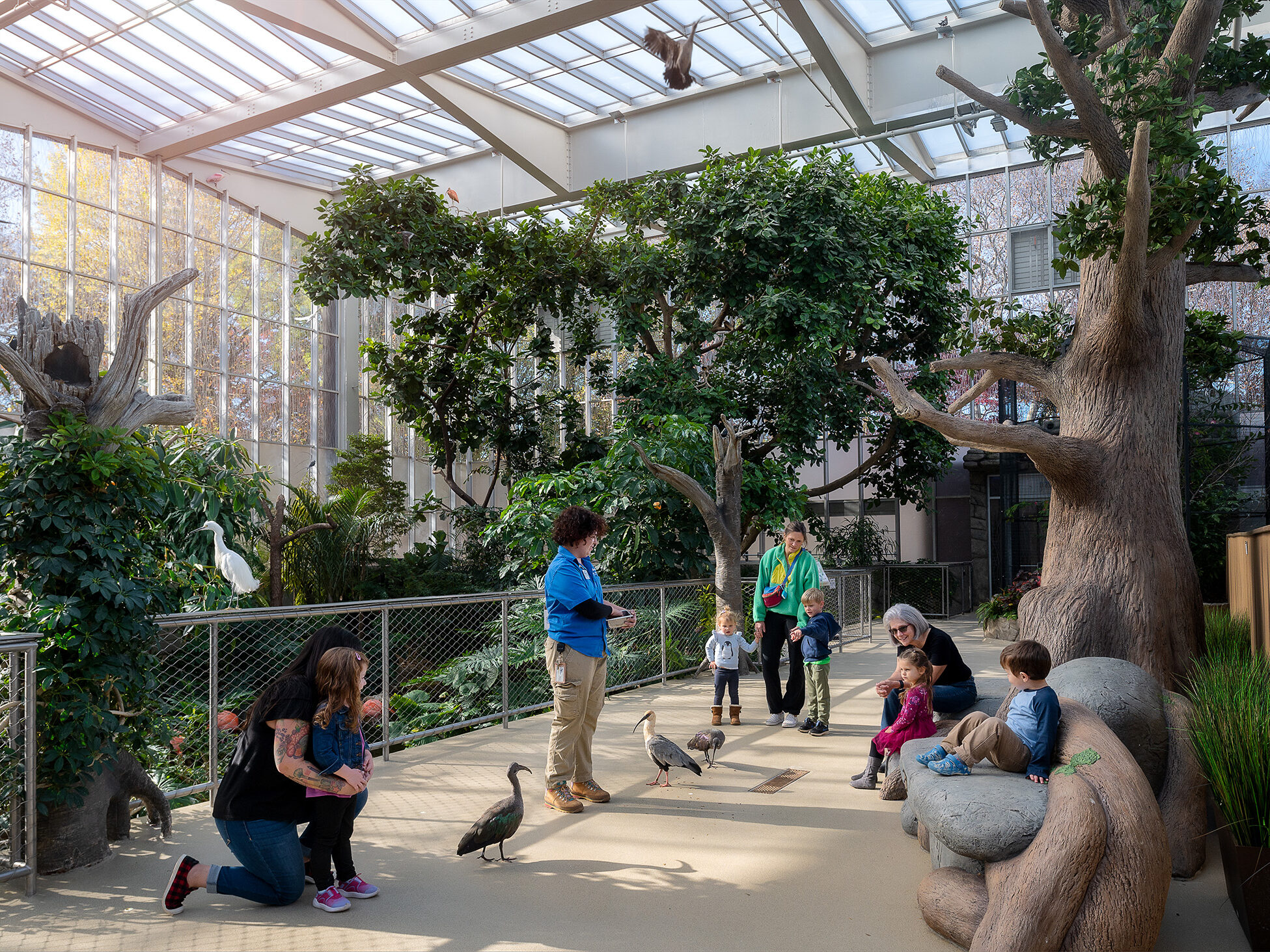 Guests watching a National Aviary expert feed birds in the Wetlands habitat