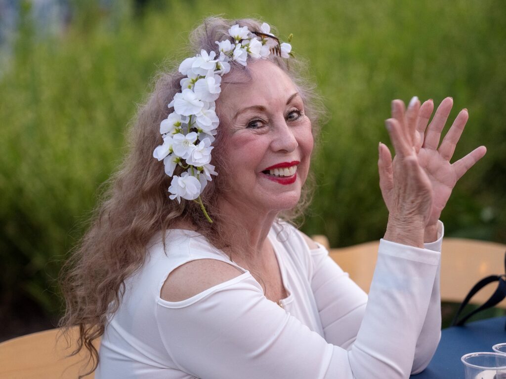 A woman wearing a floral head crown!