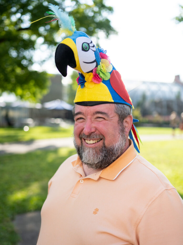 A guy wearing a macaw hat!