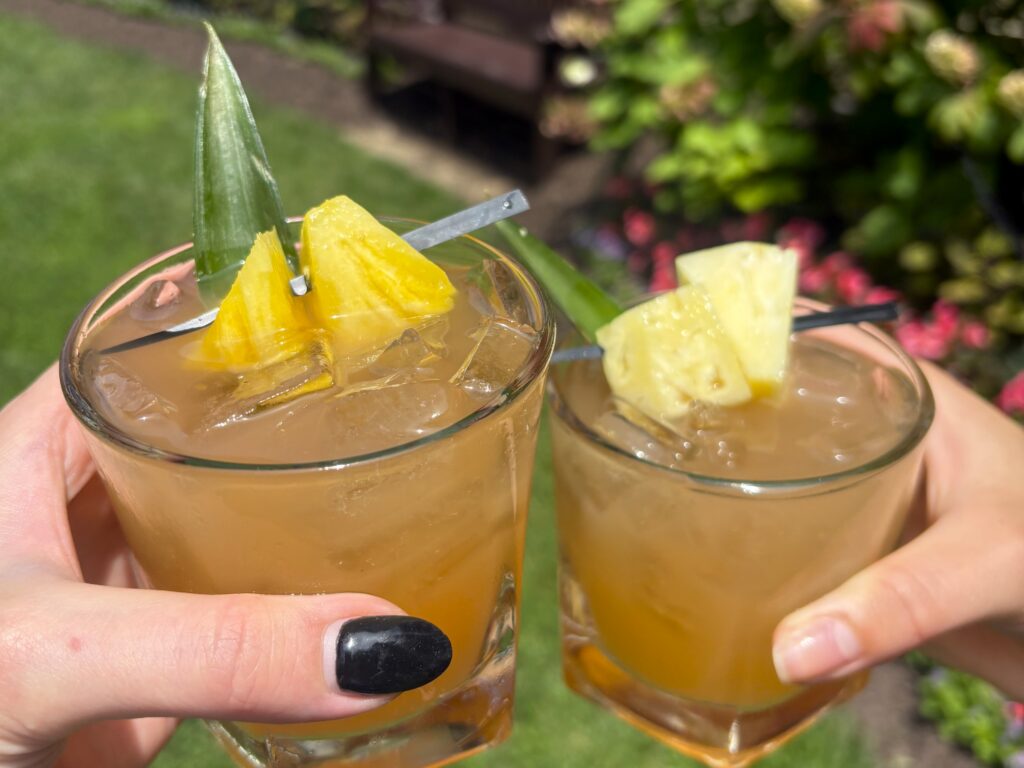 Close up of the signature cocktail featuring a pineapple slice on top